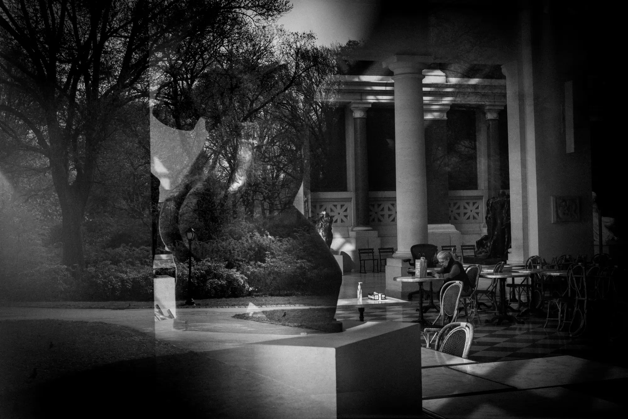 Figures and columns layered in reflection