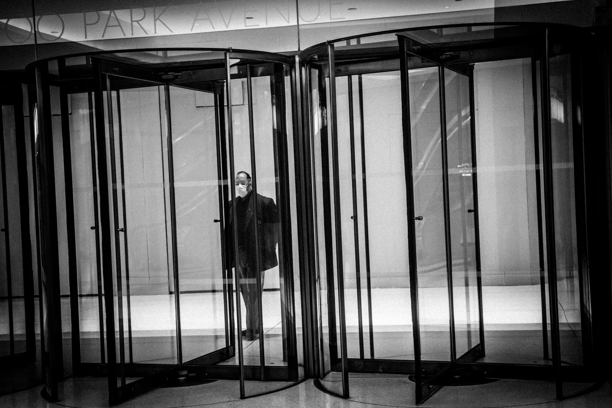 A solitary figure in a revolving door