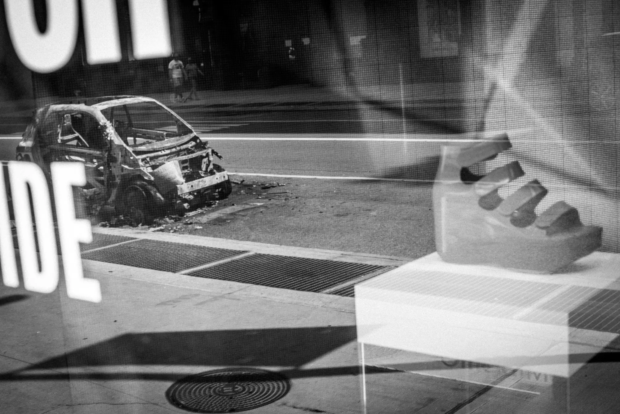 Street scene and lettering reflected in glass