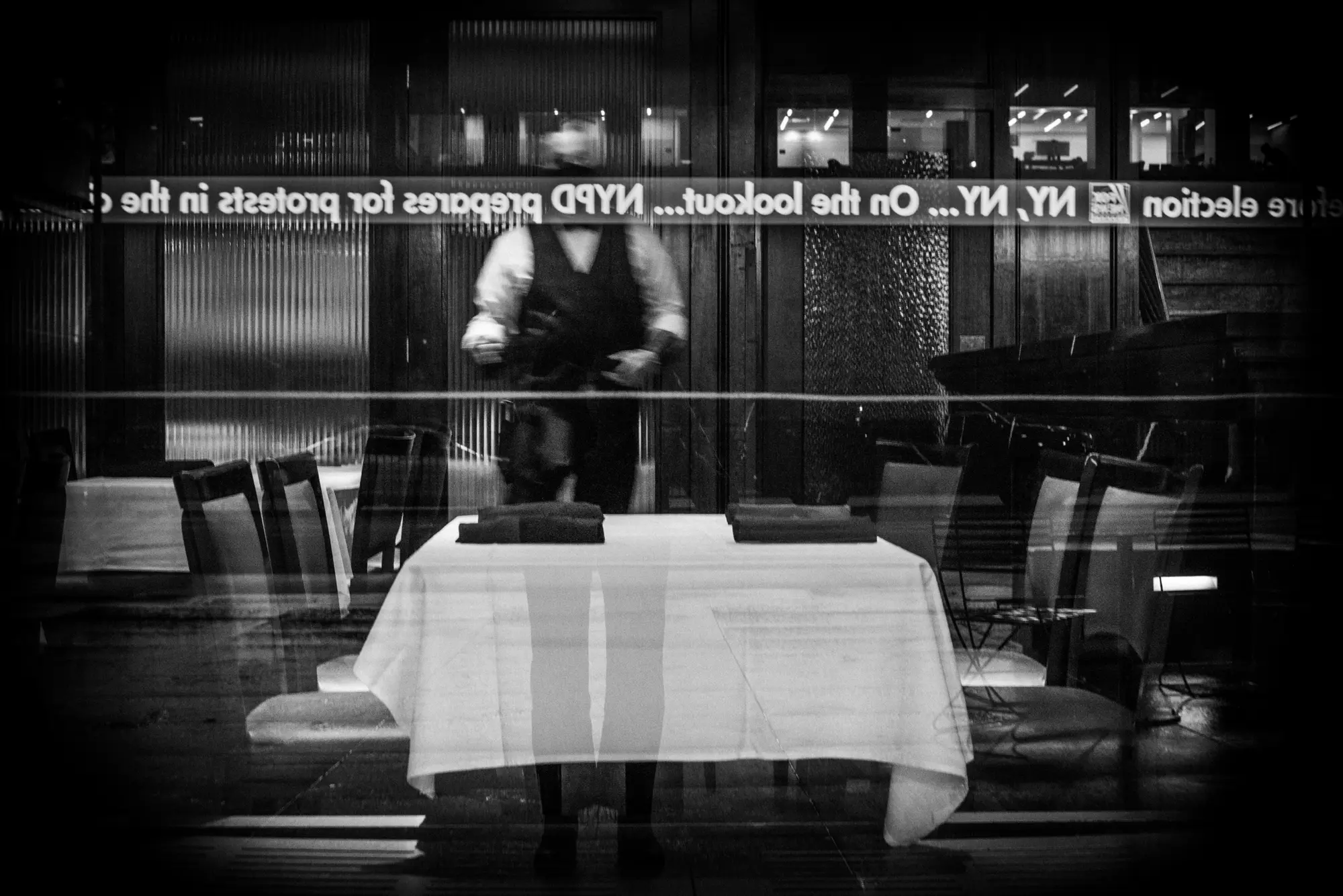 Fox News ticker reflected over an empty table